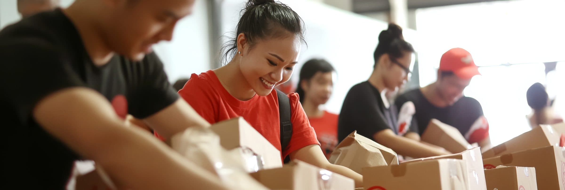 Volunteers packing care packages together at a community event
